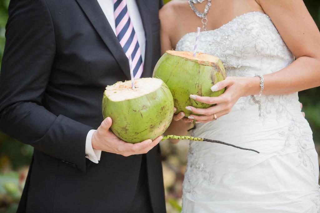 sharing coconut cocktails at destination wedding