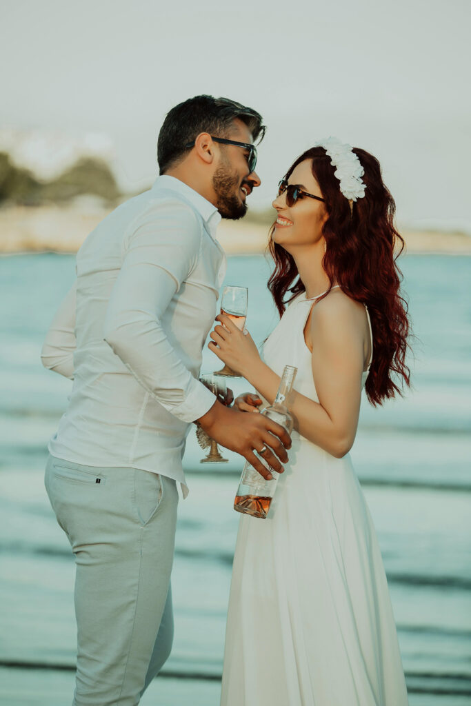 Couple celebrating on the beach with champagne, perfect moment from a destination wedding in Jamaica.
